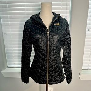 The North Face black with gold stitching quilted thermoball with hood